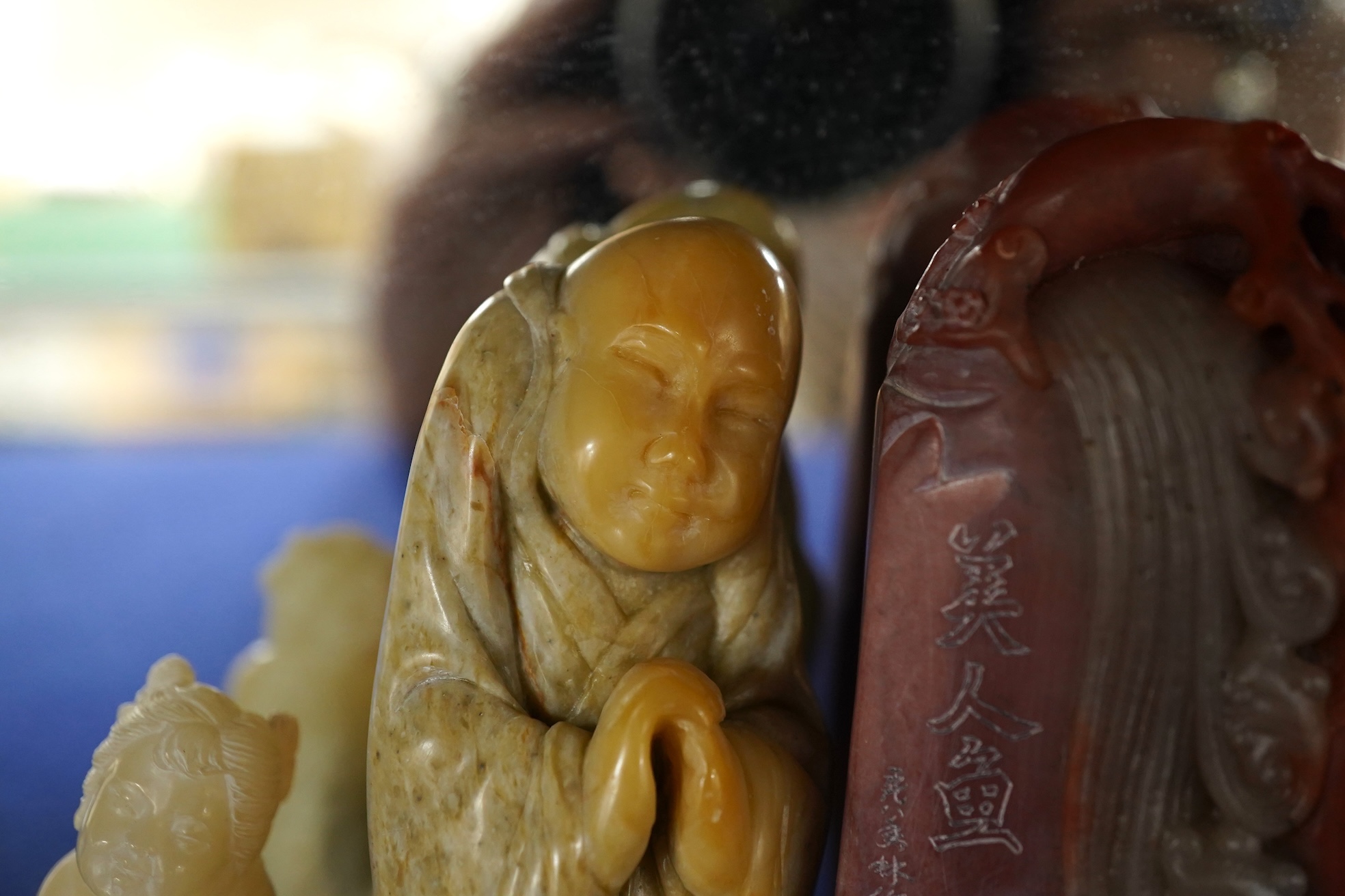 A Chinese white jade 'boys with jar' carving and three shoushan stone figures; luohan, girl with squirrel and mermaid (4), tallest 11cm